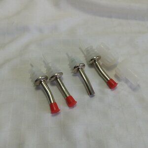 Four metal spouts (miss one cap) and two clear plastic caps